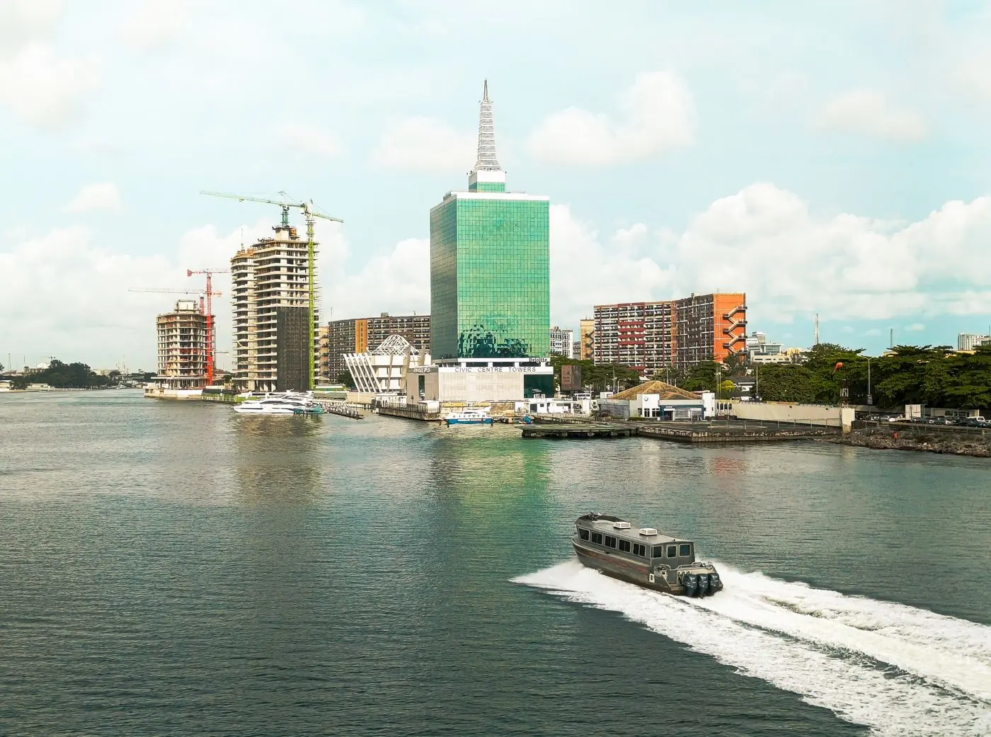 Lagos waterfront skyline with a boat crossing the lagoon