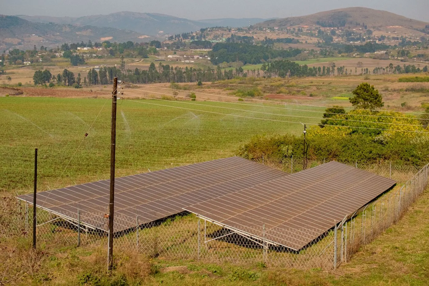 Solar panel array in a green rural landscape