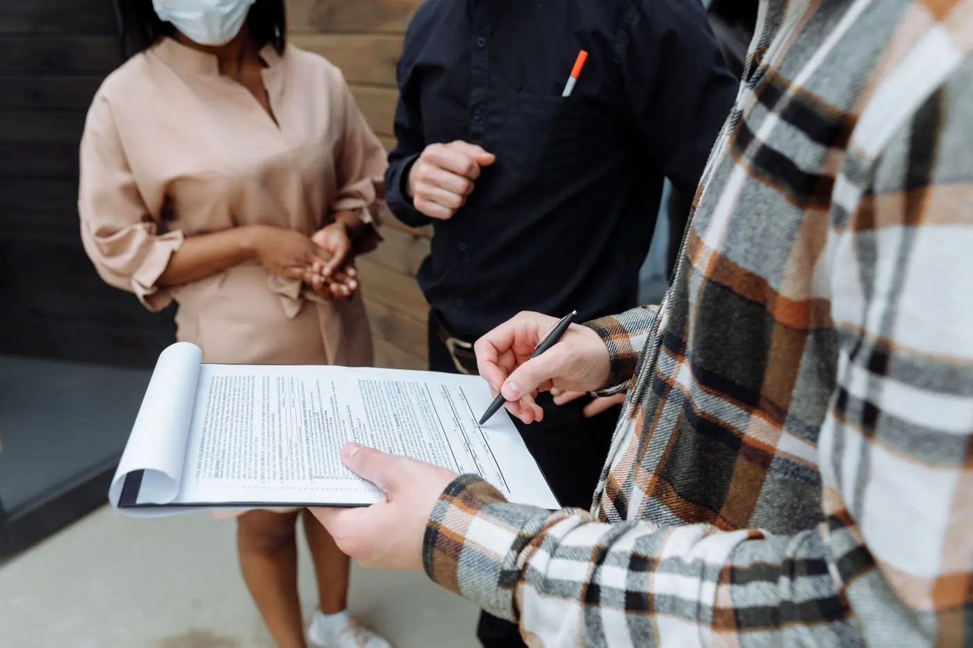 People reviewing documents on a clipboard together