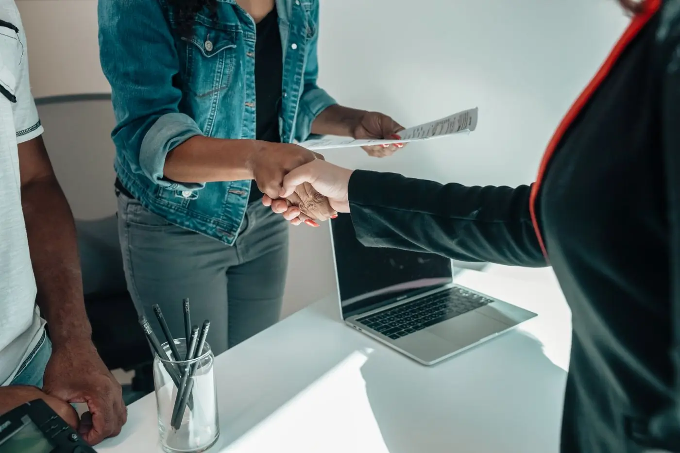 A handshake across a desk
