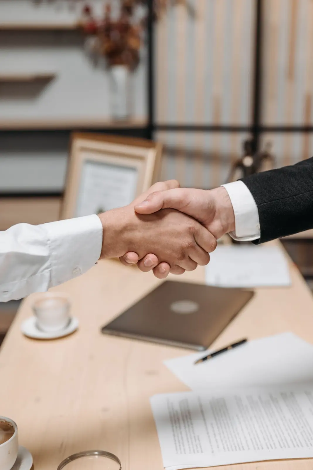 Investors shaking hands over documents